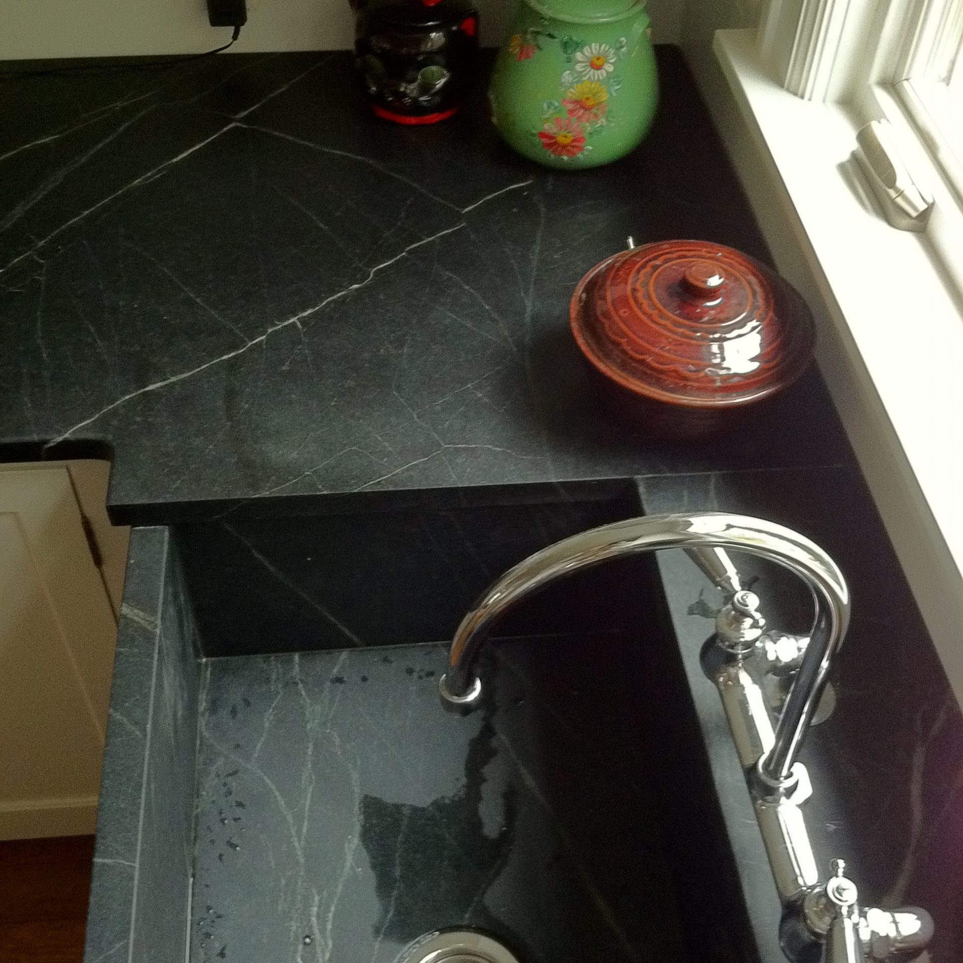 Dark stone countertop with stone sink basin